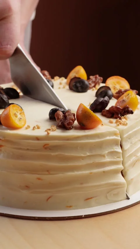 A pastry chef's hand cuts a cake in a pastry shop Stock Footage 262873768