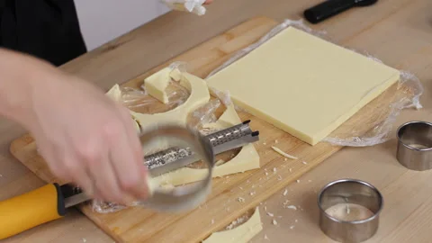 The pastry chef's hands create a shape of white chocolate. Stock Footage 172519731