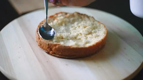 Pastry cook impregnates cake Stock Footage 67514476