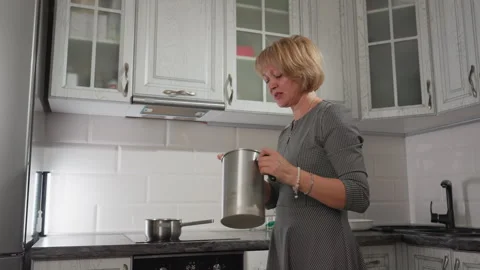 Pastry Cook Singing and Dancing While Stirring Mixture in Modern Kitchen Stock Footage 307990917