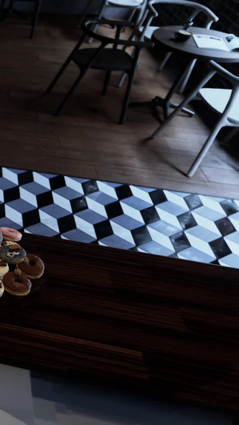 Pastry display on table in cafe with black and white patterned floor Stock Footage 339107495