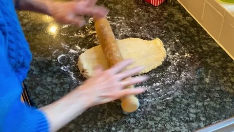 Pastry dough being rolled by elderly lady with rolling pin Stock Footage 228266580