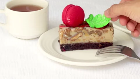 Pastry piece slice of cake rectangle shape on white plate and black tea in cup Stock Footage 218790207