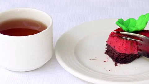 Pastry piece slice of cake rectangle shape on white plate and black tea in cup Stock Footage 218791069