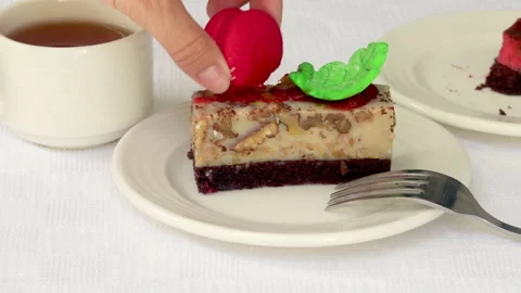 Pastry piece slice of cake rectangle shape on white plate and black tea in cup Stock Footage 218792912