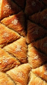 Pastry placed in a pattern under warm light at a bakery in a busy market in the Stock Photos