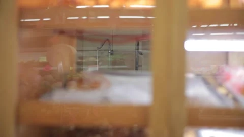 A pastry window with bakers in the background Stock Footage 231414714