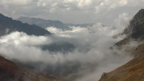 Patagonia mountain valley timelapse, clouds pour through rugged peaks, sharp Stock Footage 333769758