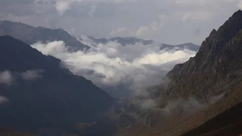 Patagonia mountain valley timelapse, clouds pour through rugged peaks, sharp Stock Footage 333775459