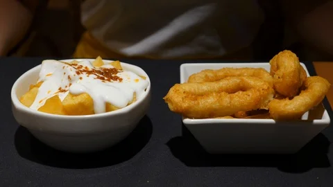 Patatas bravas and deep fried battered calamares, typical tapa at Spain 스톡 동영상 100691364
