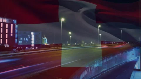 Patch appearing on highway, morphing to waving white-cross flag, obscuring light 스톡 동영상 330380410