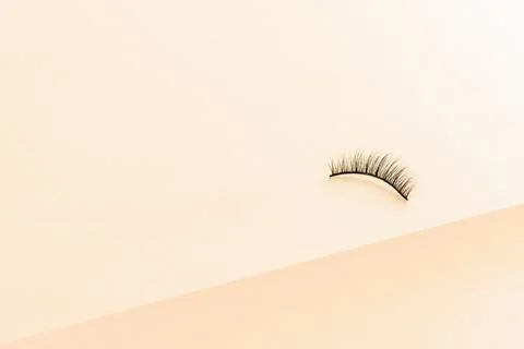 Patch eyelashes on yellow divided background. Stock Photos