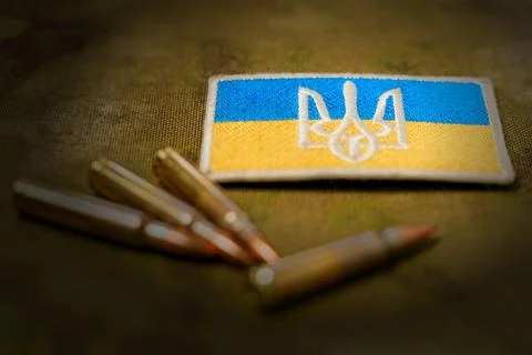 Patch with the flag and coat of arms of Ukraine, rifle cartridges on a Stock Photos