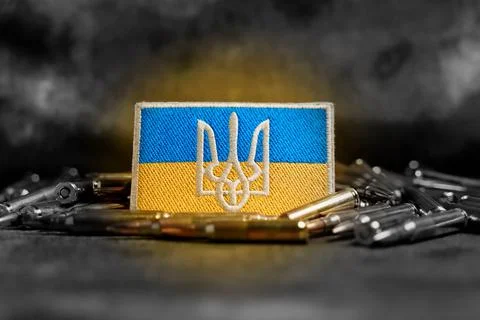 Patch with the flag and coat of arms of Ukraine, rifle cartridges on a Stock Photos