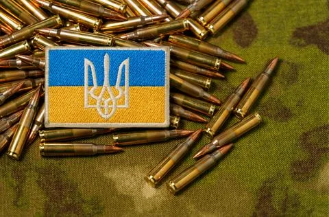 Patch with the flag and coat of arms of Ukraine, rifle cartridges on a camouf Stock Photos