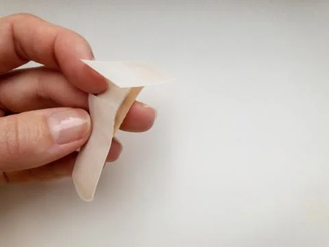 Patch in hand on a white background. Stock Photos