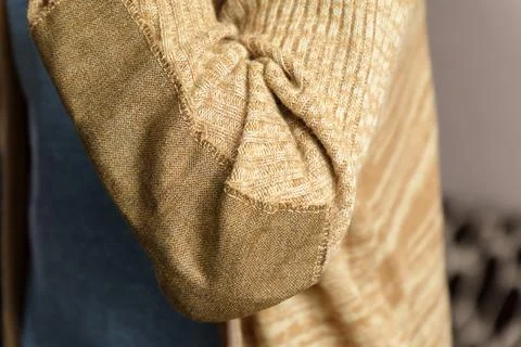 Patch on a man wool sweater. Mending clothes we sew, wear, repair. Selective  Stock Photos