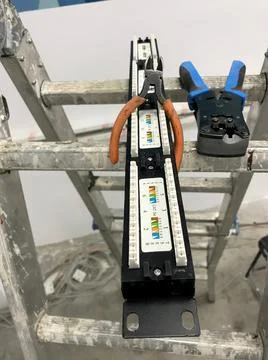 Patch panel with two pliers on a ladder closeup view with selective focus on  Stock Photos