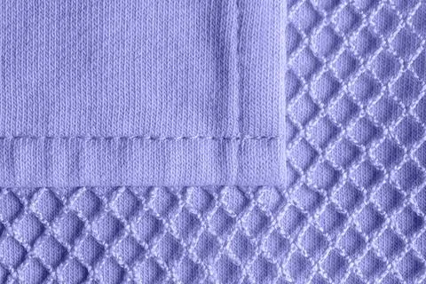 Patch pocket on blue violet mesh cotton jersey macro. Texture. Stock Photos