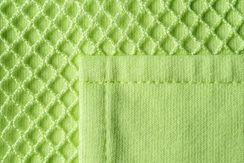 Patch pocket on green mesh cotton jersey macro. Texture. Stock Photos