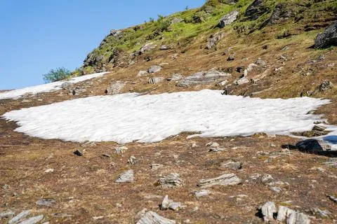 Patch of snow in summer at Mount Storsteinen in Tromso, Norway Stock Photos