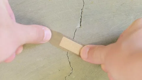 A patch is stuck on a crack in a concrete wall. Unscrupulous repair concept Stock Footage 267795633
