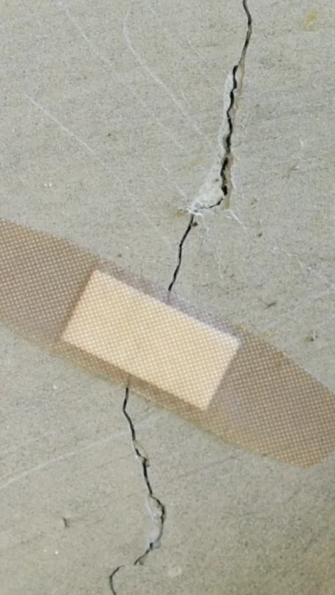 A patch is stuck on a crack in a concrete wall. Unscrupulous repair concept Stock Footage 269091935