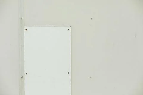 Patch on wall. Texture of white wall with inserts. Broken surface. Stock Photos