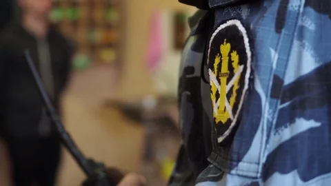 Patch with the word "Law" on prison officer uniform in the cell, close-up Stock Footage 81582330