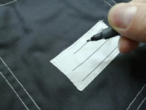 Patch on work clothes to write the name of the owner. Close-up of a clean name Stock Photos