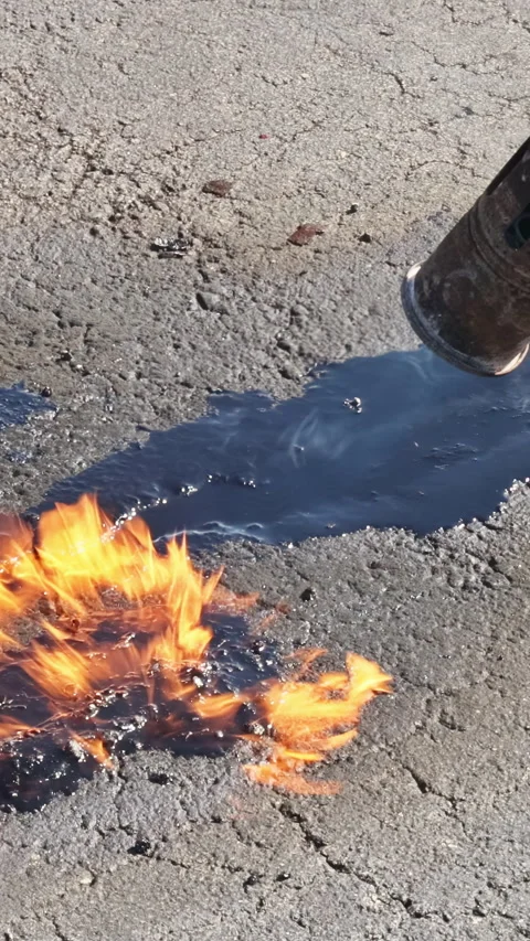 Patcher performs coating, sealing, emulsion application while restoring road Stock Footage 258768539