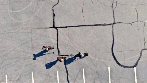 Patcher performs work that involves coating asphalt cracks, sealing them Stock Footage 272560805