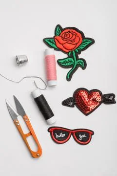 Patches, scissors, thread and thimble Stock Photos