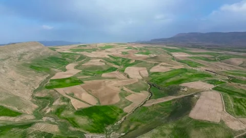 Patchwork Agricultural Fields and Mountain Valley from Above Stock Footage 342941695