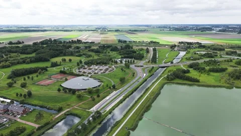 Patchwork agricultural fields canals green parks spread across landscape curving Stock Footage 327668843