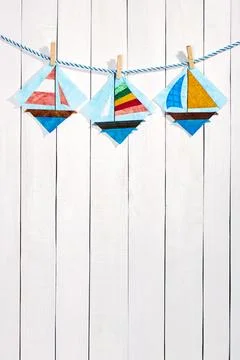 Patchwork blocks attached with clothespins on a rope on a white wooden back.. Stock-Fotos