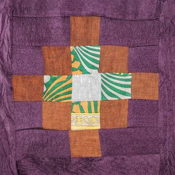 Patchwork with brown pattern on purple fabric Stock Photos