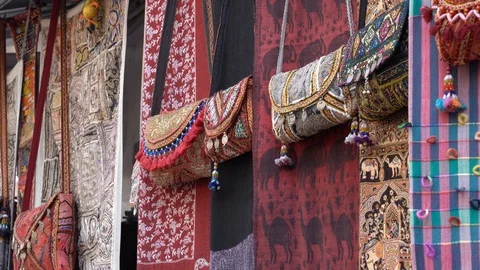 Patchwork carpets and homemade bags in local street market, Rajasthan, India Stock Footage 114488340