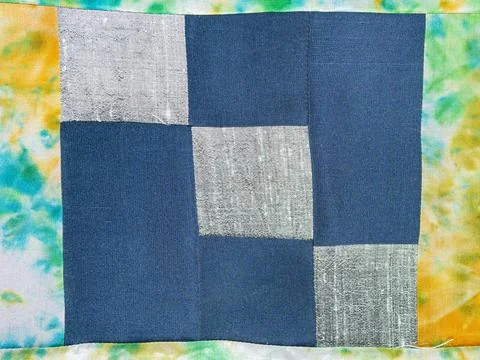 Patchwork cloth with blue and silver fabrics Stock Photos