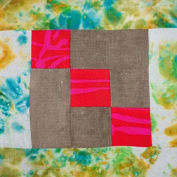 Patchwork cloth from red and brown fabrics Stock Photos