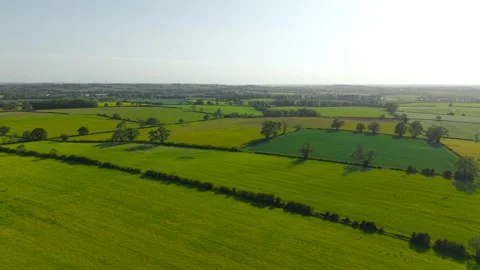 Patchwork countryside fields under spring sunshine covering rolling agricultural Video stock 337415196