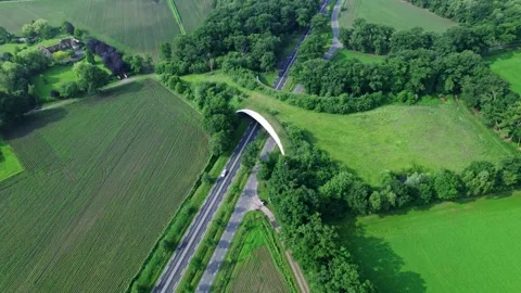 Patchwork Dutch agrarian landscape with arrow shaped ecoduct overpass interstate 스톡 동영상 311638740