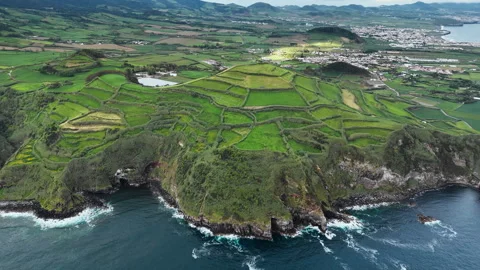 Patchwork farmland fields above rocky Atlantic shore on Sao Miguel Island Stock Footage 324749648