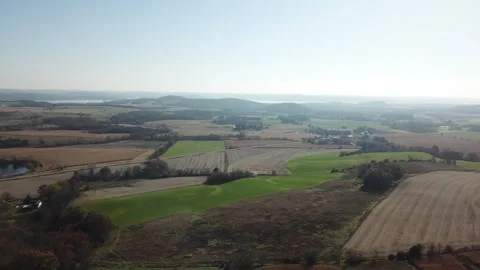 Patchwork farmland landscape with distant hills – aerial view Stock Footage 311969406