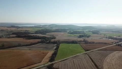 Patchwork farmland with road and distant hills Stock Footage 311968926
