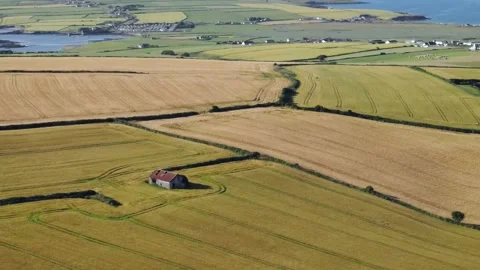 Patchwork of fields and farms with background of campsites and ocean views Stock Footage 157483215