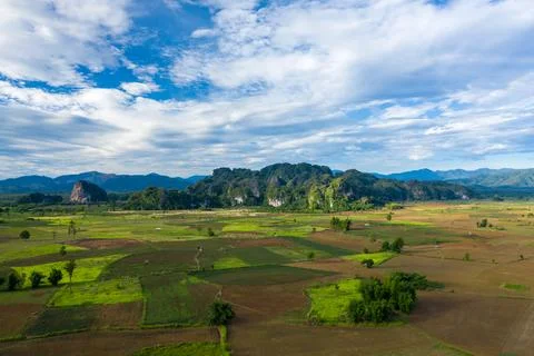 Patchwork fields and limestone hills under blue sky Fotos de archivo