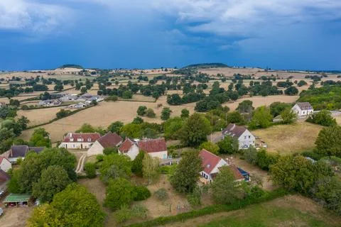Patchwork fields and village before summer storm Stock Photos