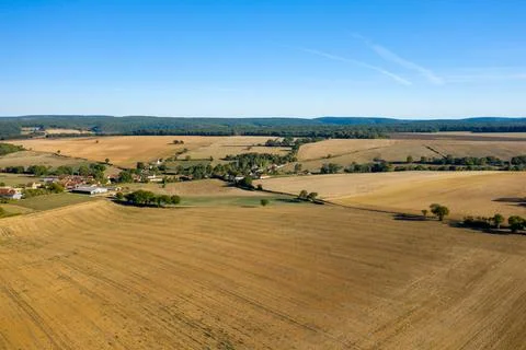 Patchwork fields and village under blue sky 스톡 사진
