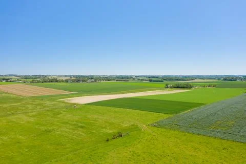 Patchwork fields under clear blue sky in Normandy 스톡 사진